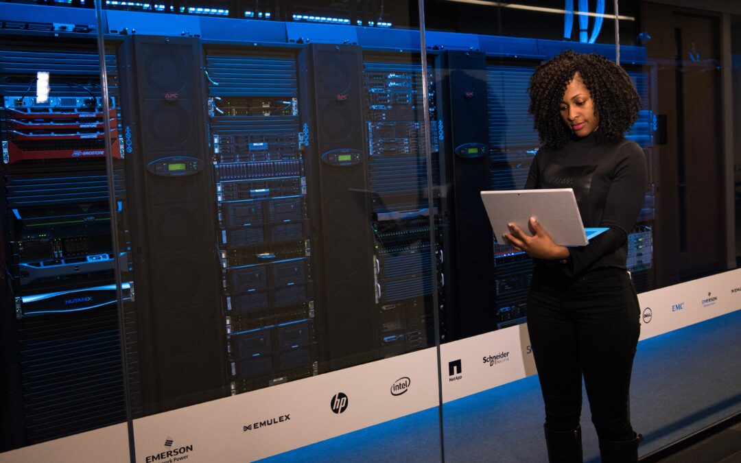 Lady on an I-Pad in a Global Data Center with Servers