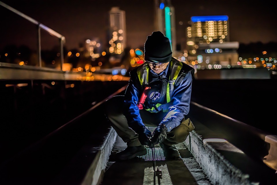 Railroad technician installing temperature sensor
