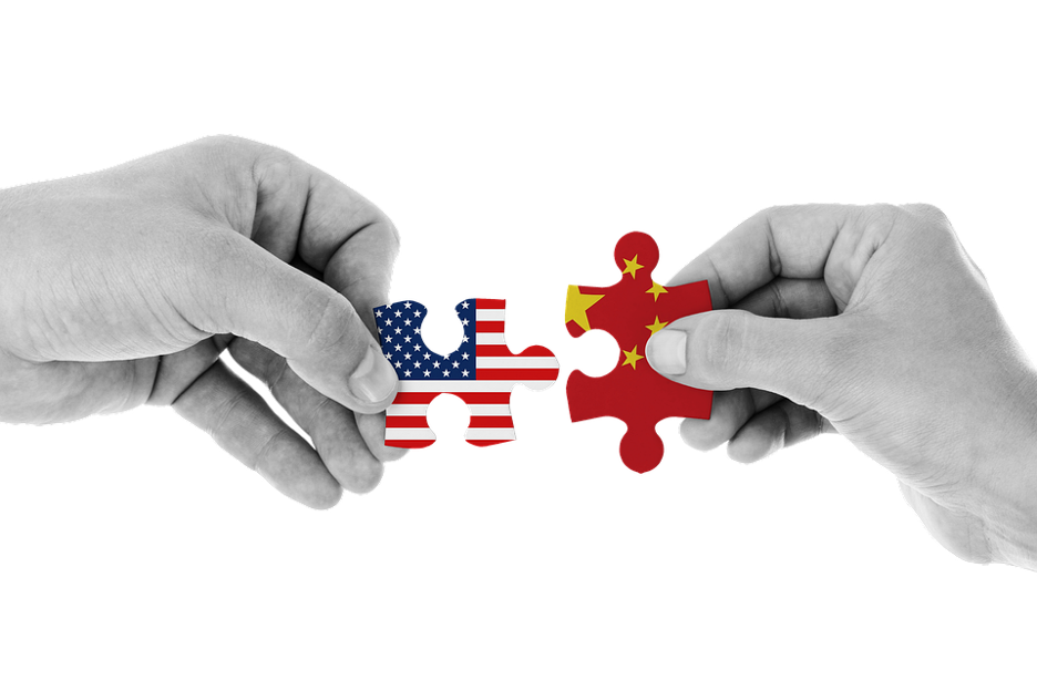 Hands holding US and China Puzzle Pieces
